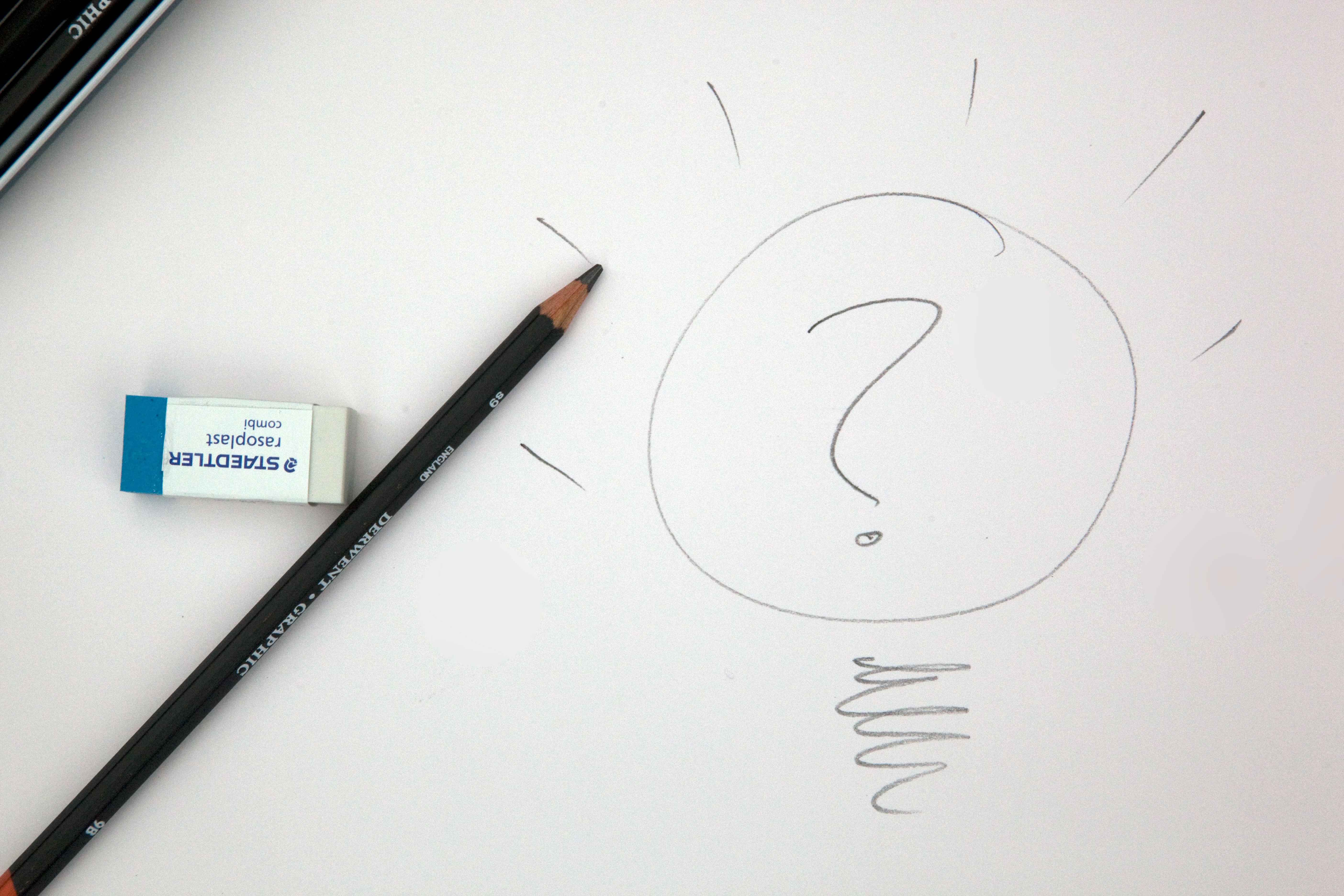 Pencil and a hand-drawn lightbulb — long-term strategy and ideas